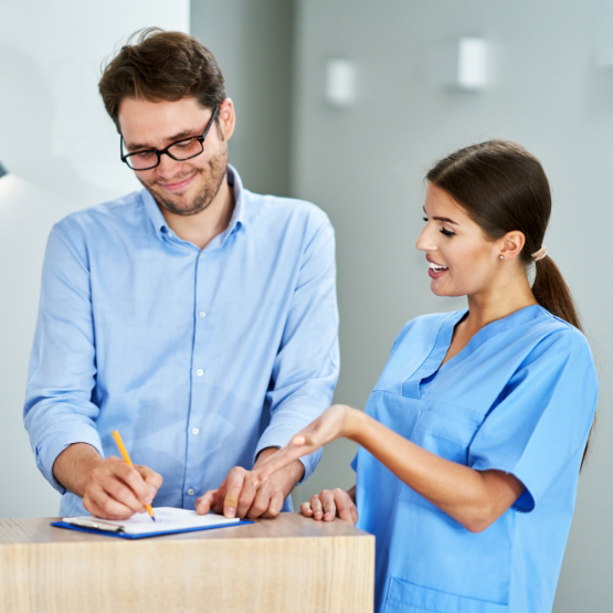 Dental team member talking to a patient about dental insurance in Tallahassee