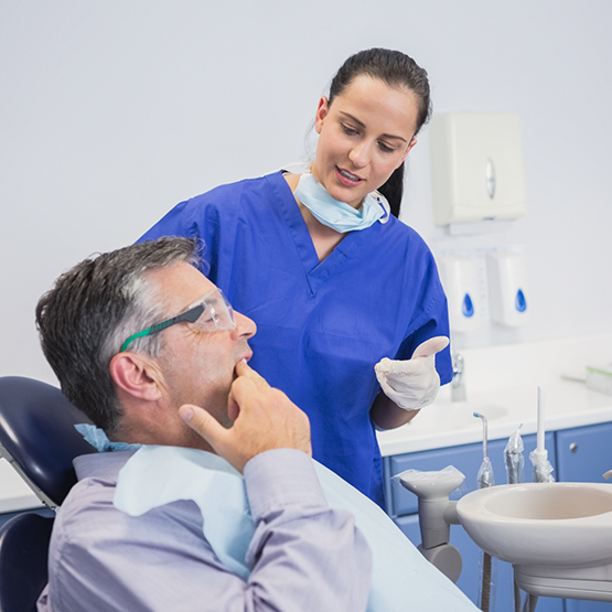 Man talking to his dentist about dentures in Tallahassee