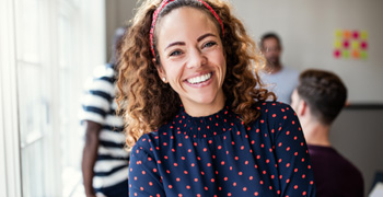 Woman in polka dot shirt smiling