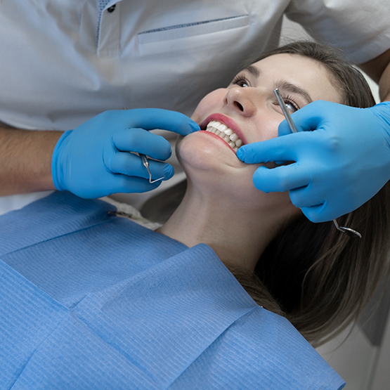 Woman having her mouth examined by her dentist