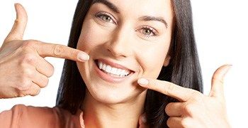 Woman pointing to her teeth