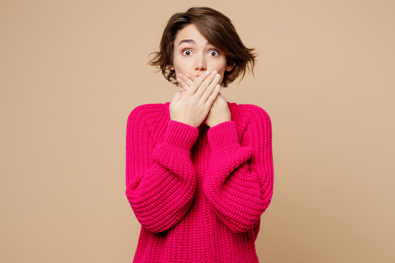 Patient covering their mouth due to dental mistakes